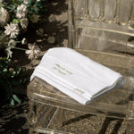 White towel with text on a clear chair outdoors