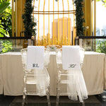 Decorative table setting with chairs and a yellow birdcage-like structure in an outdoor setting.