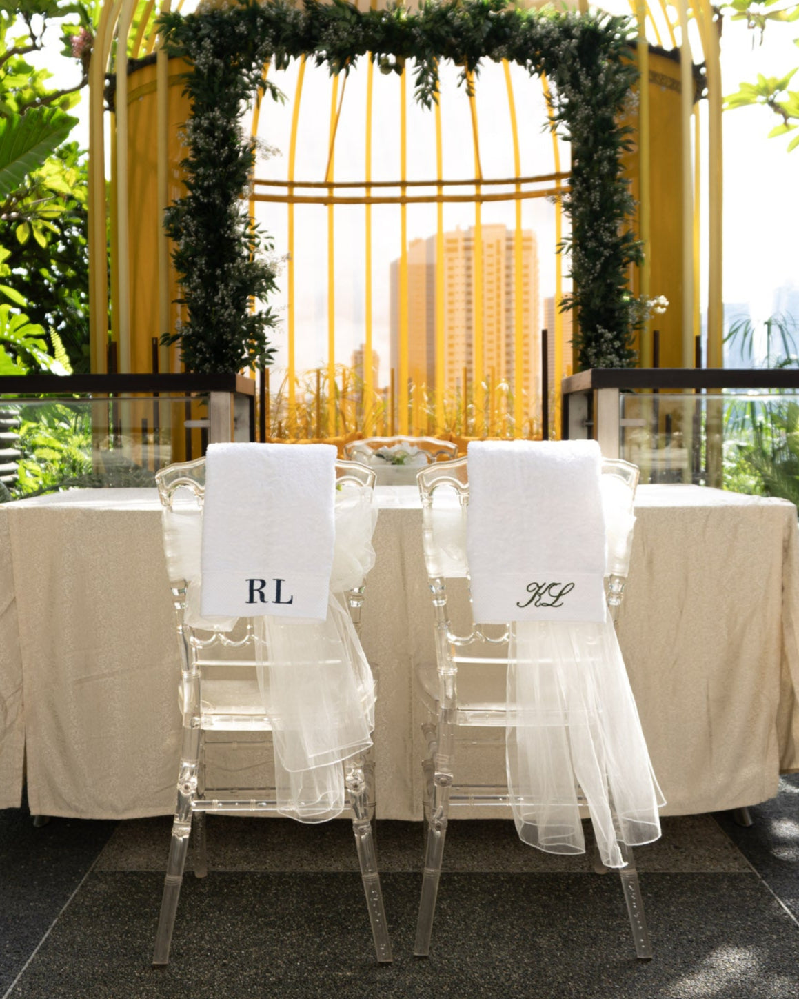 Decorative table setting with chairs and a yellow birdcage-like structure in an outdoor setting.